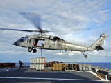 Buy An MH-60s Seahawk Helicopter Prepares to Deliver Ammunition at AllPosters.com