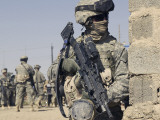 Us Army Soldier Armed with a Mk 48 Light Machine Gun, Provides Rear Security During Civil Affairs