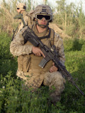 Saqlawiyah, Iraq, a Combat Engineer Assumes a Kneeling Position as He Provides Security in a Field