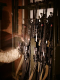 A Marine with the Incident Response Platoon Pulls an M-4 Rifle off of the Weapons Rack