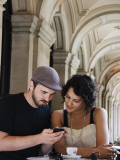 Couple at Cafe at Gpo Using Mobile Phone to Access Travel Information Photographic Print