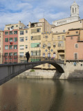 Buy Woman Crossing Pont D'En Gomez Above Onyar River before Colourful Old Buildings at AllPosters.com