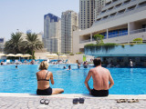 Buy Couple Sitting by a Swimming Pool in the 40 Degree Heat at AllPosters.com