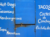 Locked Food Stall with Items for Sale Advertised on Front