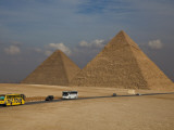 Tour Buses and Cars Driving by Pyramids of Giza