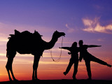 Tourists with Camel Silhouetted at Sunset at Sam Sand Dunes in Great Thar Desert.