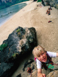 Buy Young Boy Climbing Rocks Above Beach at AllPosters.com