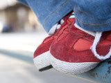 Red Tennis Shoes on Railing