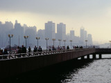 People on the Esplanade, and a View of Hong Kong Island Shrouded in a Twilight Mis