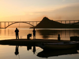 Couple Fishing from Stone Pier with Krk Bridge Joining Krk Island to Mainland