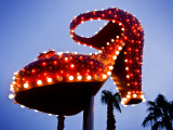 Red Neon Shoe Glowing at Dusk Along Fremont Street