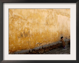 A Little Girl Rests at a Wall