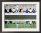 With the Water Reflection, a Muslim Man Walks Past Others Offering the Friday Prayer at a Mosque