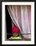 A Nepali Child Looks out from a Window at Pro-Democracy Activists