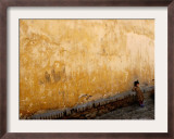 A Little Girl Rests at a Wall