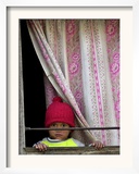 A Nepali Child Looks out from a Window at Pro-Democracy Activists
