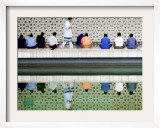With the Water Reflection, a Muslim Man Walks Past Others Offering the Friday Prayer at a Mosque
