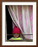 A Nepali Child Looks out from a Window at Pro-Democracy Activists