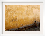 A Little Girl Rests at a Wall