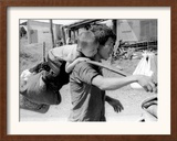 A South Vietnamese Father Carries His Son and a Bag of Household Possessions