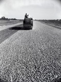 Buy Highway Construction Worker Operating Heavy Machinery on Loose Gravel Road at AllPosters.com