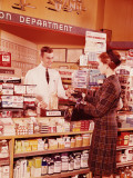 Buy Woman at Pharmacy Counter Talking To Pharmacist at AllPosters.com