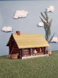 Toy Model of Log Cabin With Tree Grass Sky Clouds