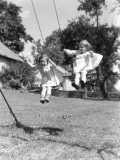 Two Girls on Backyard Swing Set Swinging Playing Fun Summer