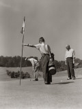 Golfer Getting Ready To Putt With Boy Caddy