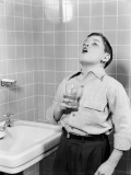 Boy Gargling in Bathroom