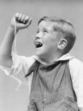 Buy Boy Holding String Tied To Loose Front Tooth at AllPosters.com
