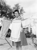 Buy Woman Wearing a White Collar Poka Dot Cotton Dress While Pinning a Towel on a Clothes Line at AllPosters.com