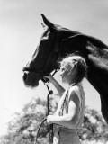 Little Girl Holding Horse By Halter