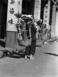 Female Paper Flower Vendor Carrying Two Large Baskets of Artificial Flowers, Hong Kong