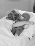 Little Girl Asleep in Bed, With Arm Around Teddy Bear