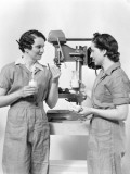 Two Women Workers Standing Near Drill Press, Eating Sandwich and Drinking Milk