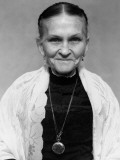 Elderly Woman Wearing Shawl and Pocket Watch Around Neck