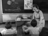 Teacher and Primary School Students in Classroom