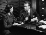 Businessman Talking To Secretary at Desk