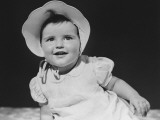 Baby Girl (12-18 Months) in Bonnet Smiling, Close-Up