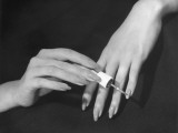 Close-Up of Hands Putting on Nail Polish
