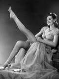 Woman in Evening Wear Pullin on Silk Stockings