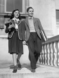 Teen Couple With Books Walking Outside School