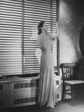 Woman Adjusting Widow Blind