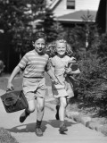 Boy and Girl Running With Books