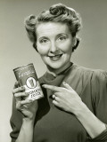 Woman Holding Can of Tomato Juice