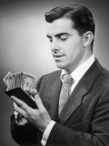 Man Counting Money in His Wallet