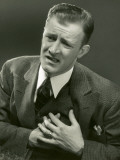 Man Clutches Left Side of Chest