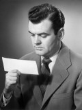 Man Looking at Paycheck