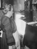 Mature Woman Using Telephone, Wearing Apron